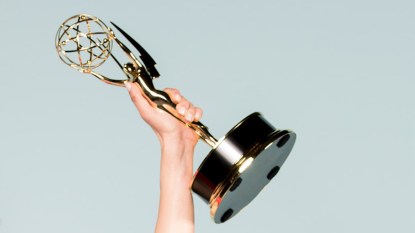 Holding an Emmy Award Trophy